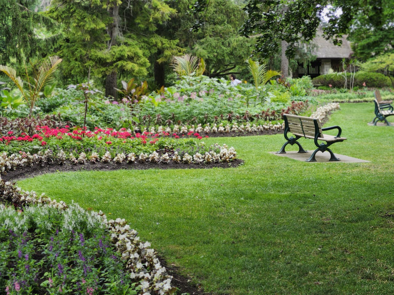 Mastering the First Impression: Your intriguing post title goes here Beautiful garden with benches and vibrant flowers in a Toronto park during the day.